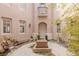 Picturesque courtyard featuring a stone waterfall feature, lush greenery, and comfortable seating at 11241 Golden Chestnut Pl, Las Vegas, NV 89135