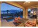 Cozy covered patio with comfortable seating overlooking the pool and lush greenery at 11241 Golden Chestnut Pl, Las Vegas, NV 89135