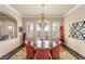 Formal dining room showcasing an elegant chandelier, outdoor views, and designer furnishings at 11241 Golden Chestnut Pl, Las Vegas, NV 89135