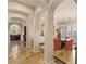 Elegant dining room with marble floors, grand columns, and a stylish chandelier at 11241 Golden Chestnut Pl, Las Vegas, NV 89135