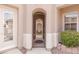 Welcoming entryway with an ornate iron gate and a decorative brick planter at 11241 Golden Chestnut Pl, Las Vegas, NV 89135