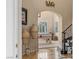 Elegant foyer with marble floors, a grand staircase, and an arched doorway leading to the game room at 11241 Golden Chestnut Pl, Las Vegas, NV 89135