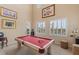 Bright game room featuring a billiard table, natural light, and comfortable seating at 11241 Golden Chestnut Pl, Las Vegas, NV 89135