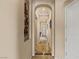 Elegant hallway with arched doorways and decorative tile flooring, creating a sophisticated path at 11241 Golden Chestnut Pl, Las Vegas, NV 89135
