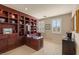 Inviting home office with custom built-in shelves, elegant desk, and bright windows at 11241 Golden Chestnut Pl, Las Vegas, NV 89135
