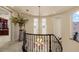 Spacious landing with wrought iron railing, chandelier, and view of the landscape at 11241 Golden Chestnut Pl, Las Vegas, NV 89135