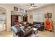 Well-lit living room boasts a large entertainment unit and comfortable leather sofas at 11241 Golden Chestnut Pl, Las Vegas, NV 89135