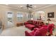 Bright living room featuring comfortable seating and natural light from the French doors at 11241 Golden Chestnut Pl, Las Vegas, NV 89135