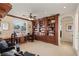 Home office featuring custom wood built-in bookshelves, desk, and comfortable seating at 11241 Golden Chestnut Pl, Las Vegas, NV 89135