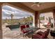 Covered patio with lounge chairs, fireplace, swimming pool and mountain views at 11241 Golden Chestnut Pl, Las Vegas, NV 89135