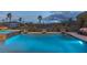 Spacious swimming pool and spa with decorative features, surrounded by desert landscaping and mountain views at 11241 Golden Chestnut Pl, Las Vegas, NV 89135
