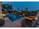 Backyard pool area with lounge area, water feature, and fire pit at 11241 Golden Chestnut Pl, Las Vegas, NV 89135