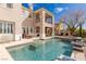 Stunning backyard oasis with a sparkling pool, spa, and covered patio, perfect for outdoor entertaining at 11241 Golden Chestnut Pl, Las Vegas, NV 89135