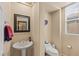 Convenient powder room with pedestal sink, modern fixtures, and a neutral color palette at 11241 Golden Chestnut Pl, Las Vegas, NV 89135