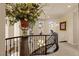 Beautiful staircase with dark wood railing, decorative accents and natural light from the nearby windows at 11241 Golden Chestnut Pl, Las Vegas, NV 89135