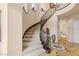 Grand staircase with ornate iron railing, carpeted steps, and decorative floor medallion at 11241 Golden Chestnut Pl, Las Vegas, NV 89135