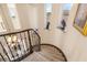 Elegant curved staircase features plush carpeting and decorative wrought iron railing with accent lighting at 11241 Golden Chestnut Pl, Las Vegas, NV 89135
