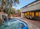 Backyard boasts a custom spa with waterfall feature and covered patio with dining area at 11660 Intervale Rd, Las Vegas, NV 89135