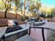 Outdoor living space with a fire pit and spa with custom rock waterfall feature at 11660 Intervale Rd, Las Vegas, NV 89135