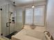 Bright bathroom featuring a soaking tub, walk-in shower, modern finishes, and white shutters at 11660 Intervale Rd, Las Vegas, NV 89135