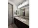 Granite countertop bathroom vanity featuring dual sinks, modern fixtures and decorative lighting at 11660 Intervale Rd, Las Vegas, NV 89135