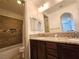 Bathroom featuring granite counters, a shower over tub, and dark wood cabinets at 11660 Intervale Rd, Las Vegas, NV 89135