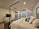 Beautiful main bedroom featuring a four-poster bed, wood floors and an ensuite bathroom at 11660 Intervale Rd, Las Vegas, NV 89135