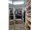 Walk-in closet with custom shelving, a full length mirror and neutral colored wood floors at 11660 Intervale Rd, Las Vegas, NV 89135