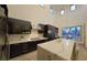 Modern kitchen featuring stainless steel appliances, marble countertops, and an island overlooking an outdoor living space at 11660 Intervale Rd, Las Vegas, NV 89135
