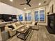 Cozy living room featuring a comfortable sectional sofa, fireplace, and abundant natural light at 11660 Intervale Rd, Las Vegas, NV 89135