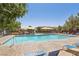 Community pool and lounge area with shade structures, lounge chairs, and mature trees at 11660 Intervale Rd, Las Vegas, NV 89135