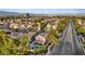 This aerial view of a home has lush landscaping and proximity to the mountains at 1229 Triumph Ct, Las Vegas, NV 89117
