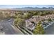 An aerial view of a home has mature landscaping and a view of the nearby mountains at 1229 Triumph Ct, Las Vegas, NV 89117