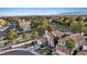 Aerial view of a residential neighborhood featuring lush greenery and houses with red tile roofs at 1229 Triumph Ct, Las Vegas, NV 89117