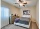 Neutral colored bedroom with dark wooden ceiling fan, carpet, and a large window at 124 Strone St, Henderson, NV 89012