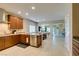 Well-lit kitchen with wooden cabinets, granite counters, stainless steel appliances and an island at 124 Strone St, Henderson, NV 89012