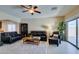 Comfortable living room with black leather sofas, tile floors, and plenty of light at 124 Strone St, Henderson, NV 89012