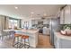Modern kitchen and dining area with stainless steel appliances, quartz countertops, and breakfast bar at 1401 Brady Bay Pl # 108, North Las Vegas, NV 89084
