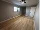 Bedroom with light gray walls, wood-look floors, and a ceiling fan at 150 Greenbriar Townhouse Way, Las Vegas, NV 89121