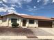 Charming single-story home with a terracotta tile roof, an attached two-car garage, and freshly landscaped front yard at 1608 Joshua Tree Ct, Las Vegas, NV 89108