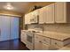 Well-lit kitchen with white cabinets, marble-style counters, and stainless steel appliances at 1608 Joshua Tree Ct, Las Vegas, NV 89108
