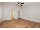 Spacious bedroom with wood-look flooring, and doorways into closets and ensuite bathroom at 187 Golden Crown Ave, Henderson, NV 89002