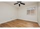 Clean bedroom featuring a ceiling fan, wood-style flooring, and a view to the exterior block wall at 187 Golden Crown Ave, Henderson, NV 89002