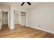 Bedroom boasting wood-style flooring, a ceiling fan, and a mirrored closet door at 187 Golden Crown Ave, Henderson, NV 89002