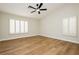Spacious bedroom with wood-look flooring, ceiling fan and bright, shuttered windows at 187 Golden Crown Ave, Henderson, NV 89002