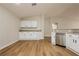 Kitchen showcasing white cabinets, stainless steel appliances, and wood-style flooring at 187 Golden Crown Ave, Henderson, NV 89002