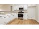 Kitchen featuring white cabinets, stainless steel appliances, and wood-style flooring at 187 Golden Crown Ave, Henderson, NV 89002