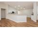 Bright, open kitchen with white cabinets, modern appliances, and a breakfast bar, seamlessly connected to the living area at 187 Golden Crown Ave, Henderson, NV 89002