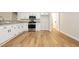 Kitchen featuring stainless appliances, white cabinets, wood floors, and a convenient pantry at 187 Golden Crown Ave, Henderson, NV 89002