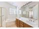 Bright bathroom with a soaking tub, double sinks, and tile floors at 1970 Jasper Creek Pl, Las Vegas, NV 89123